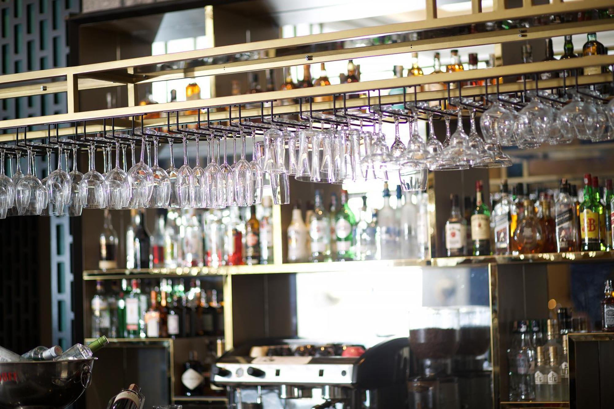 Ramada By Wyndham Istanbul Merter Esterno foto Wine glasses hanging above a bar